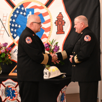 Chief Fuller Presenting Chief Konz with the Fire Chief Badge