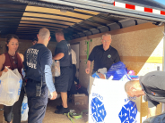 Councilman Tharp and members of Estero Fire Rescue unloading the toys from the trailer.