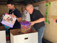 Councilman Tharp packing a box with toys.