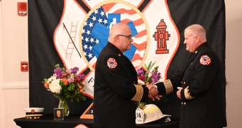Chief Fuller Presenting Chief Konz with the Fire Chief Badge